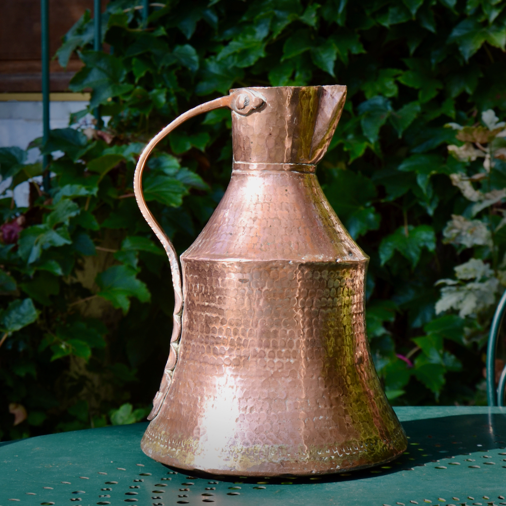 Antique hammered copper pitcher, dovetail seams